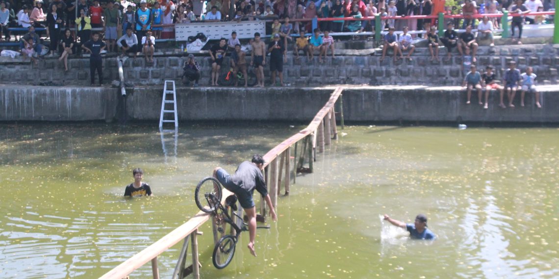 Lomba Ketangkasan Bersepeda Diatas Sungai, Peserta Tercebur Undang Gelak Tawa Penonton